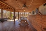 Covered outdoor deck with picnic table and outdoor hot tub